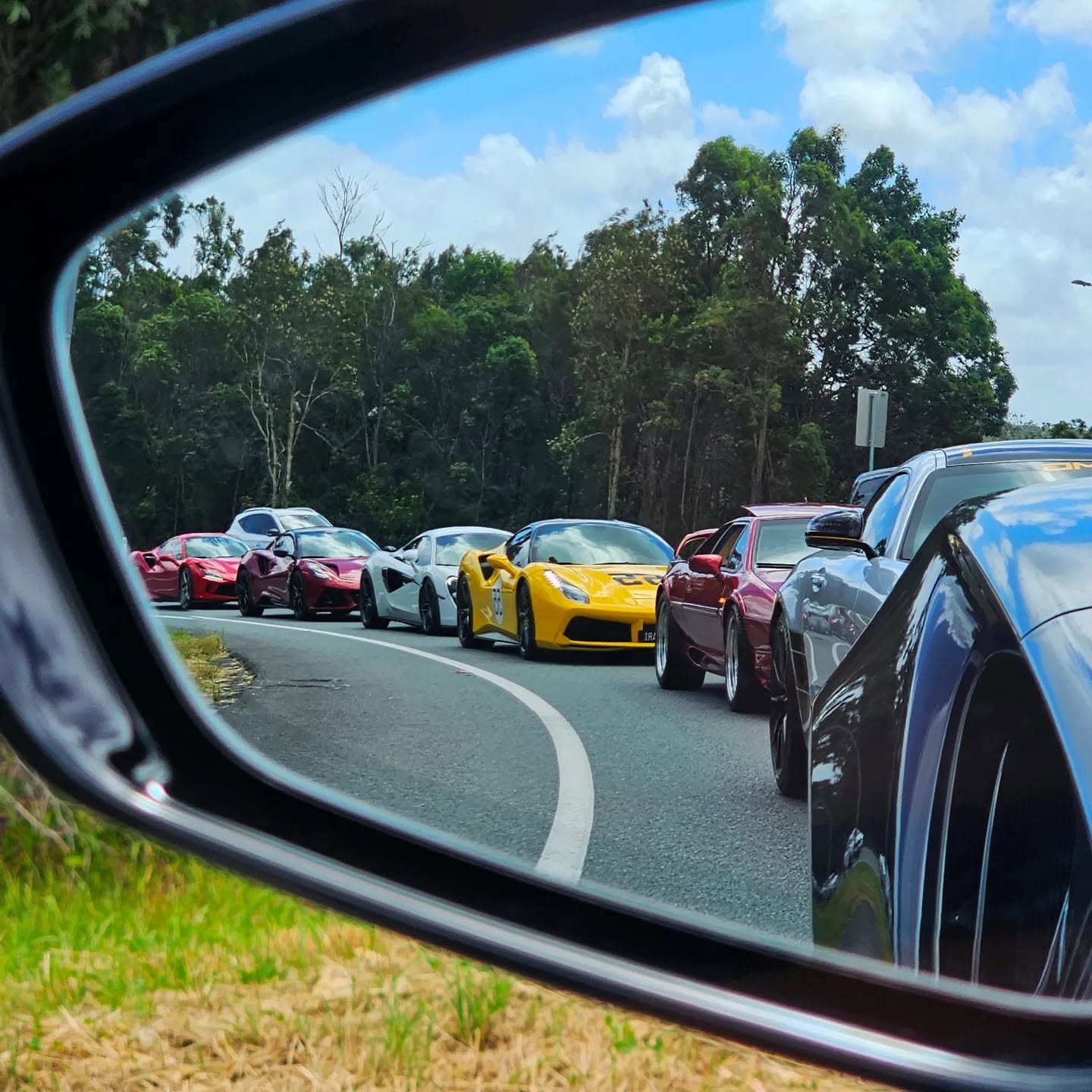 Club member's supercar parked in front of a fighter jet
